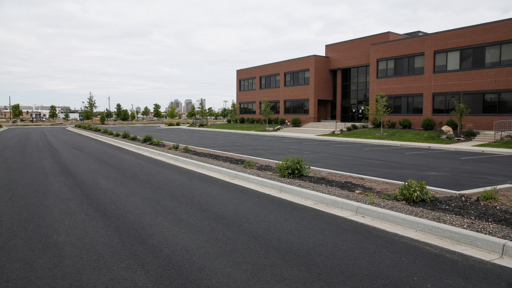 Placeholder after photo of a freshly paved asphalt parking lot.